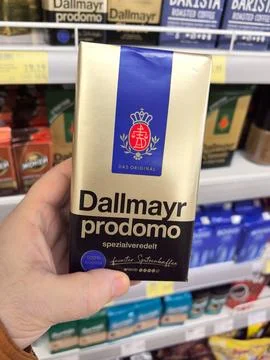 Handheld package of gourmet coffee blend showcased in a market aisle Stock Photos