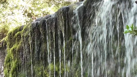 Handheld pan along top edge of waterfall Stock Footage 92576309