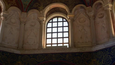Handheld Pan of Baptistery Window with Saint Bas Reliefs Stock Footage 320131132