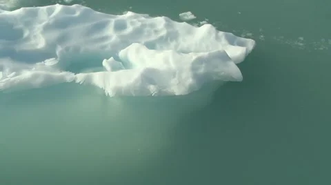Handheld pan piece of floating ice in icy iceberg waters Greenland Arctic Stock Footage 59997005