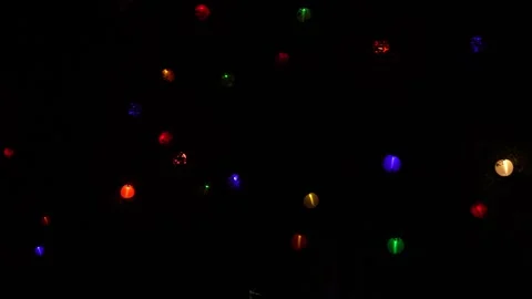 Handheld pan though glowing lanterns and paris ferris wheel at night Stock Footage 332951406