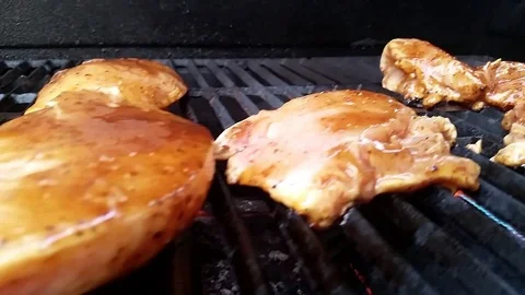 Handheld Panning Shot -- Raw Marinated Chicken on BBQ Grill Video stock 77516900