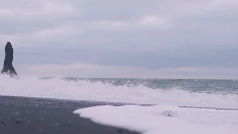 Handheld panning shot of waves along the rocky beach Stock Footage 118654663