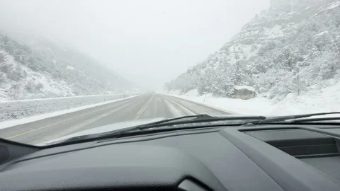Handheld POV through Truck Windshield Driving in Snow Storm in Mountains Stock Footage 256508312