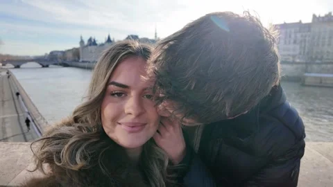 Handheld POV Young Couple in Paris Taking Selfies on Bridge Over Seine River Vídeo Stock 328105136