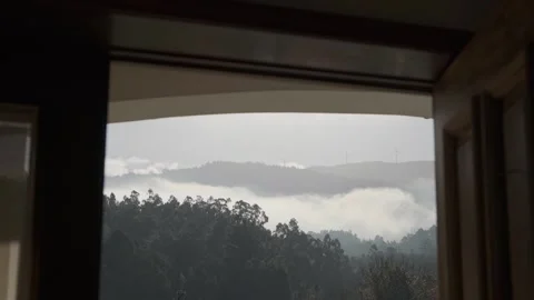 Handheld Pull-Back Shot of Arouca Mountain Windmills Seen Through a Window Stock Footage 323787932