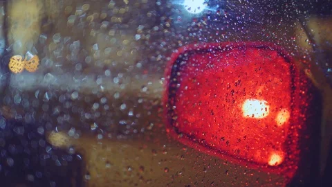 Handheld: Rain dropping on a car window, side view mirror Stock-Footage 90894631