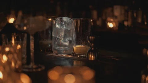 Handheld real time close up shot of a glass with ice standing on the bar. A 動画素材 129492517