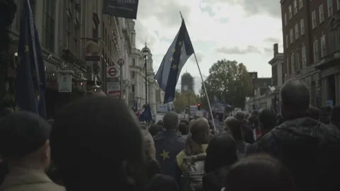 Handheld rear view of people protesting while walking on footpath Vídeo Stock 120426308