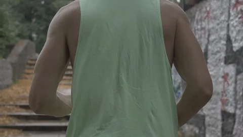 Handheld rear view of young man running up stairs Vídeo Stock 114843679