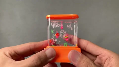 Handheld retro water game ring thumbs push for ring to swirl in water. Old toy Video stock 230964819