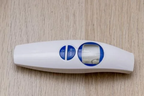 A handheld scanner device with a simple design, featuring buttons for 'SCAN' and Stock Photos