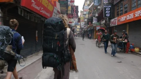 Handheld shake hippie girl dreadlocks trekking backpack market Kathmandu Nepal Stock Footage 119358193