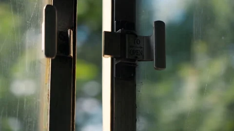 Handheld shaky video with window latch with inscription TO OPEN in old vintage Stock Footage 280663967