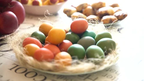 Handheld shooting. Close-up of hands putting painted eggs into a basket Stock Footage 237933859