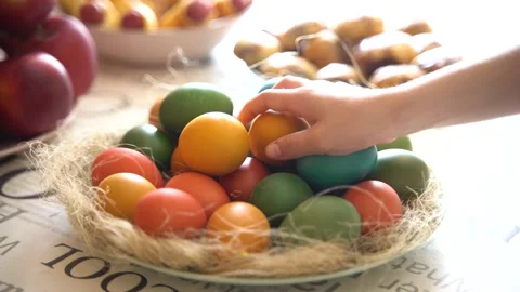 Handheld shooting. Close-up of hands taking painted eggs. Easter concept Stock Footage 237934722