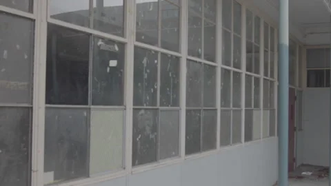 Handheld shot of abandoned classroom windows Stock Footage 252256068
