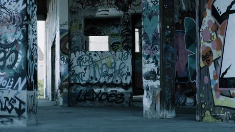 Handheld shot of abandoned warehouse full of graffiti Stock Footage 112897085