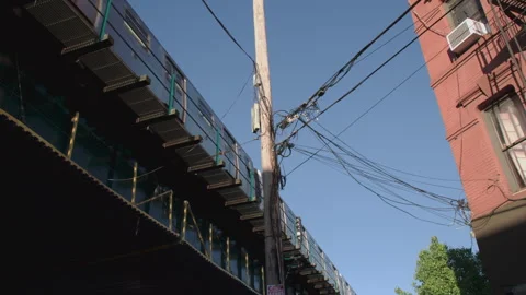 Handheld shot of an above ground subway train Stock Footage 336380767