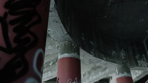 Handheld shot of architectural pillars and ceiling in abandoned warehouse Stock Footage 112895894