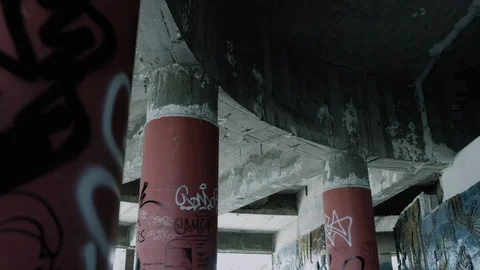 Handheld shot of architectural pillars and ceiling in abandoned warehouse Stock Footage 112895966