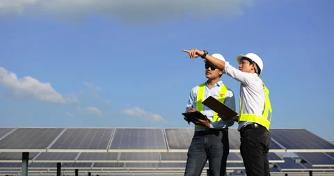 Handheld shot, Asian young engineer man and colleague in white protective  Stockbeeldmateriaal 224235223