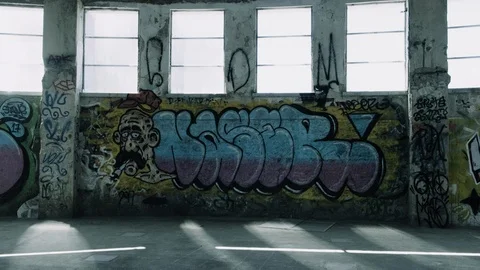 Handheld shot of big hall full o graffiti inside an abandoned house Stock Footage 112897990