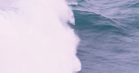 Handheld shot of big ocean wave arising from water surface and foaming up Stock Footage 156135070
