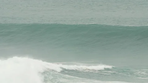 Handheld shot of big ocean waves lifting off surface of water in strong wind Stock Footage 157153384