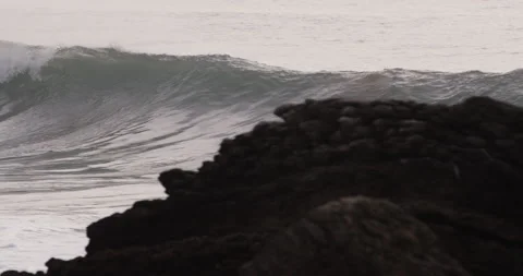 Handheld shot of big wave of atlantic ocean rolling towards seashore quickly Stock Footage 158068063