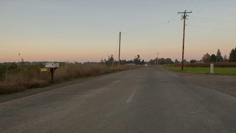 Handheld shot of biker riding motorcycle against clear sky at sunset Stock Footage