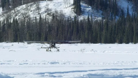 Handheld shot of black airplane before taking off in snowy land, Alaska Stock Footage 129127521
