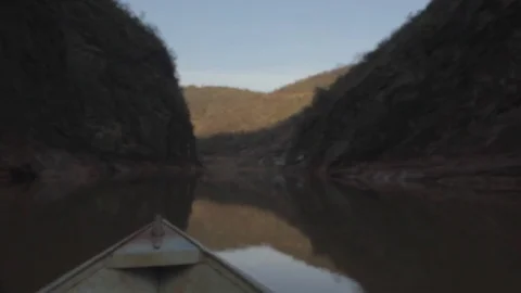 Handheld shot of a boat going downstream in a river deep in a valley in southeas Vídeos de archivo 79062340