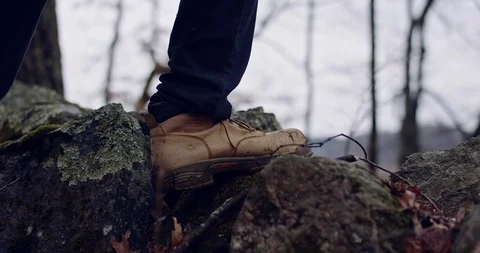 Handheld Shot of Boots Climbing Over a Stone Wall. Stock Footage 124701172