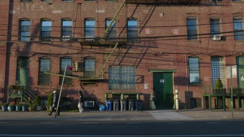 Handheld shot of a brick building at sunset Video stock 272215014