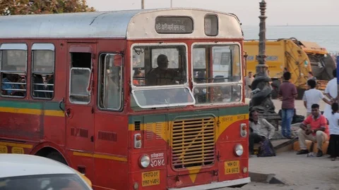 Handheld shot of bus driver driving tourism bus through busy mumbai city Stock Footage 145049965
