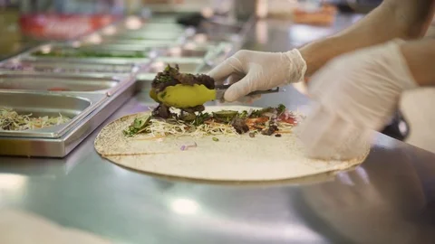 Handheld shot of chef hands in white gloves making doner in pita Stock-Footage 121853689