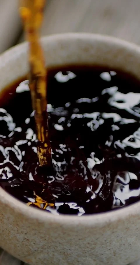 Handheld shot of Chinese tea infusion being poured into beautiful... Stock Footage 344454923