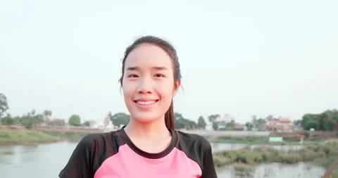 Handheld shot, Close up portrait, front view Face of young woman in sportswear Video stock 200361693