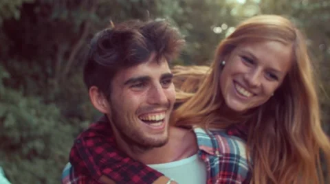 Handheld shot of couple having fun with piggyback ride Stock Footage 55278870