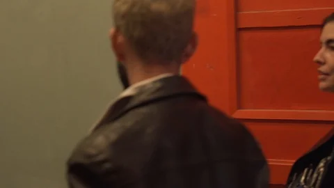 Handheld shot of couple talking while walking on street Stock Footage 114877271