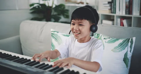 Handheld shot, Creative asian boy wearing headphone with artistic skills 스톡 동영상 241903287