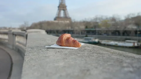 Handheld Shot of Croissant in Foreground with Eiffel Tower Paris France 스톡 동영상 324472792