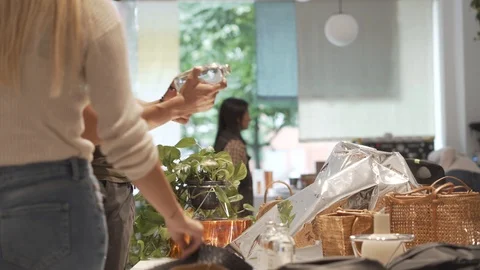 Handheld shot of customers browsing in clothing shop Stock Footage 114875475