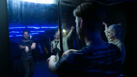 Handheld shot of dancers dancing in front of mirror on dance floor 스톡 동영상 115090202