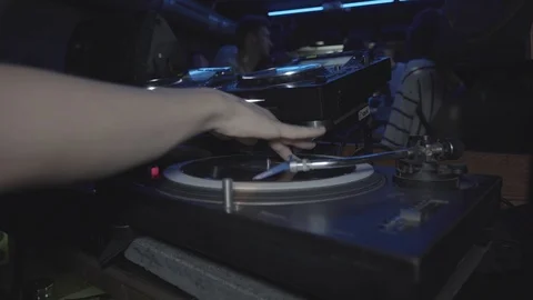 Handheld shot of a DJ spinning disk in the club Stock Footage 114881141