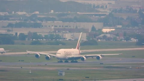 Handheld shot of Emirates plane taking off at Toronto Pearson International Stock Footage 303400386