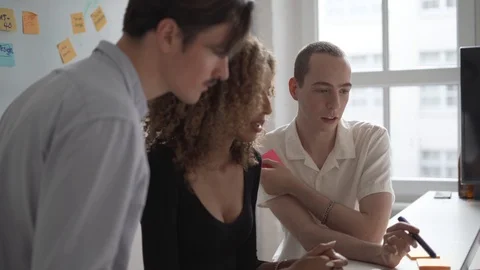 Handheld shot of executives discussing while using laptop in conference Stock Footage 114877882