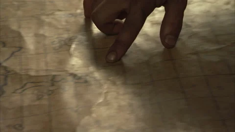 Handheld shot of explorers inspecting map on a table, 1400s - Reenactment Stock Footage 202890932