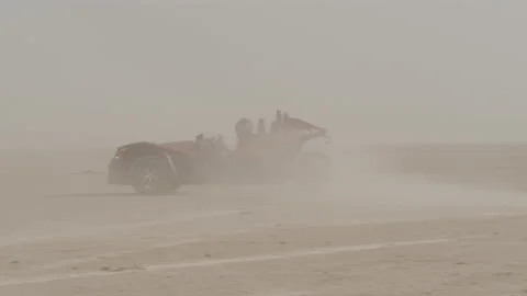 Handheld shot of Fast Car Racing and drifting In Desert with dust around Stock Footage 208757193